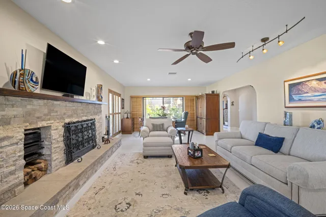 a living room with fireplace furniture and a flat screen tv