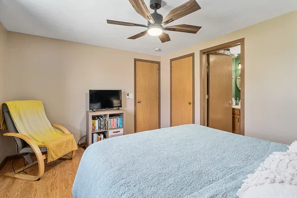 a bedroom with a bed and a flat screen tv