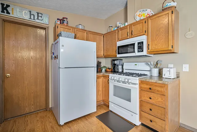 a kitchen with stainless steel appliances white cabinets and a refrigerator