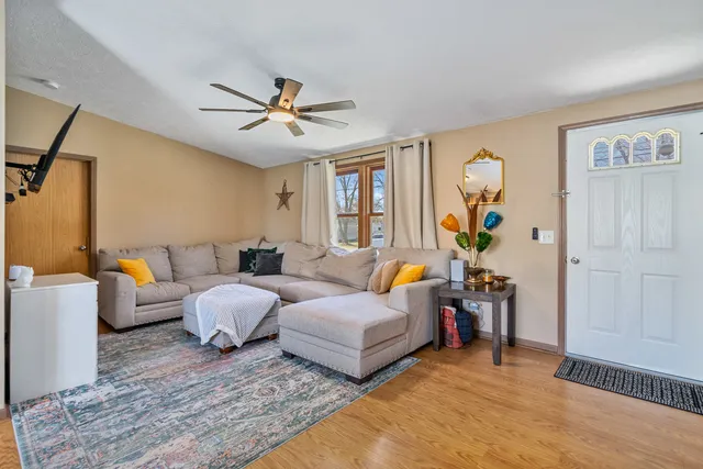 a bed room with couch and wooden floor