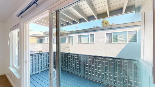 a view of balcony with wooden floor and fence