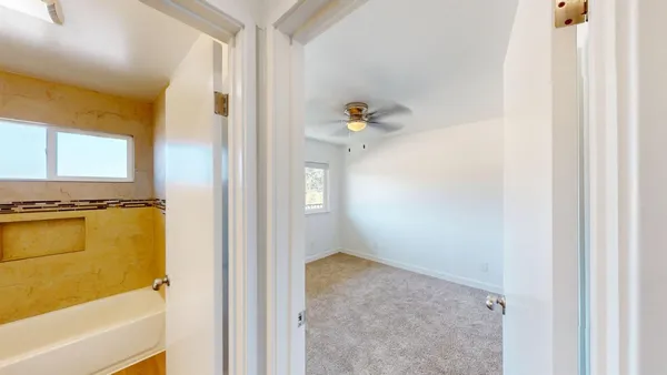 a view of walk in closet with window and bathroom