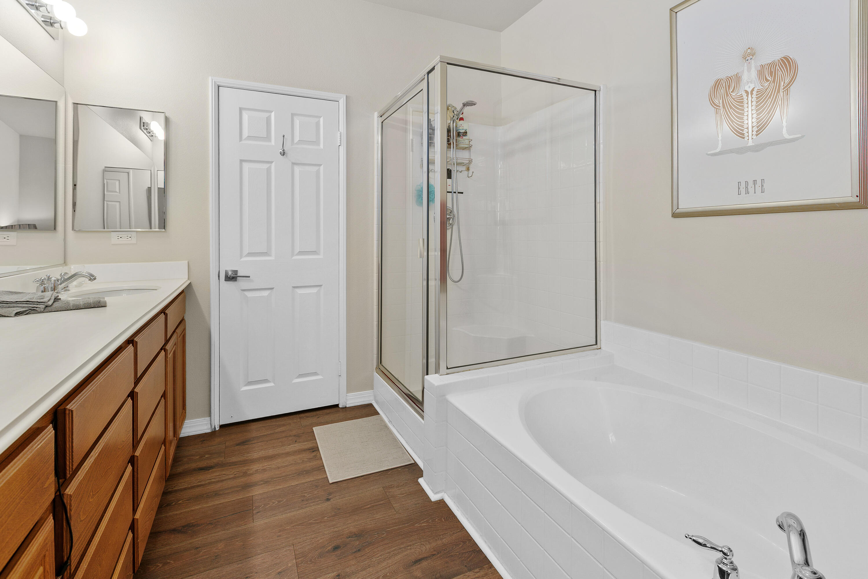 26700 Rio Dulce Road Cathedral City, CA 92234 - Photo 15 of 20 a bathroom with a tub a sink and mirrors