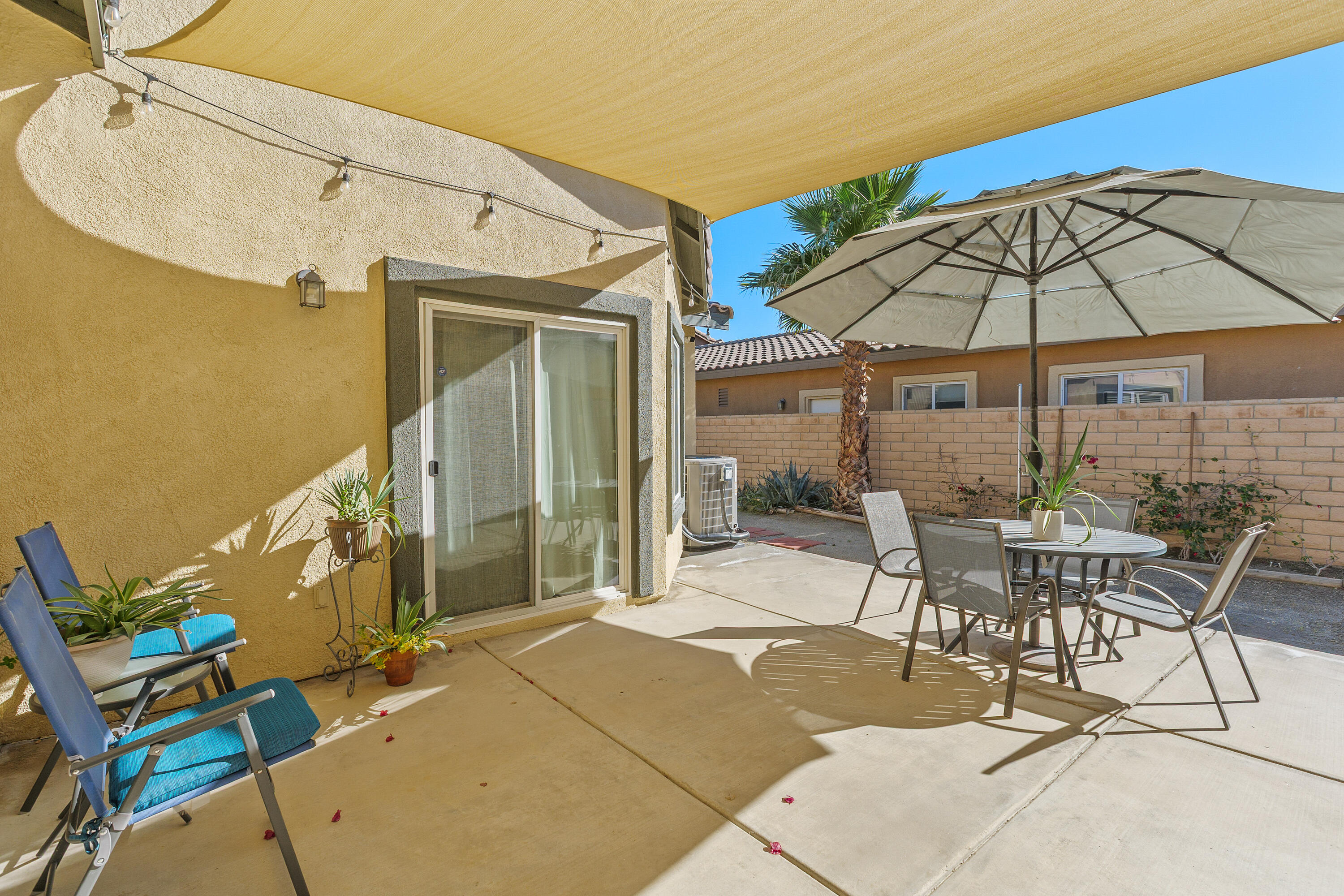 26700 Rio Dulce Road Cathedral City, CA 92234 - Photo 18 of 20 a patio with a table and chairs under an umbrella