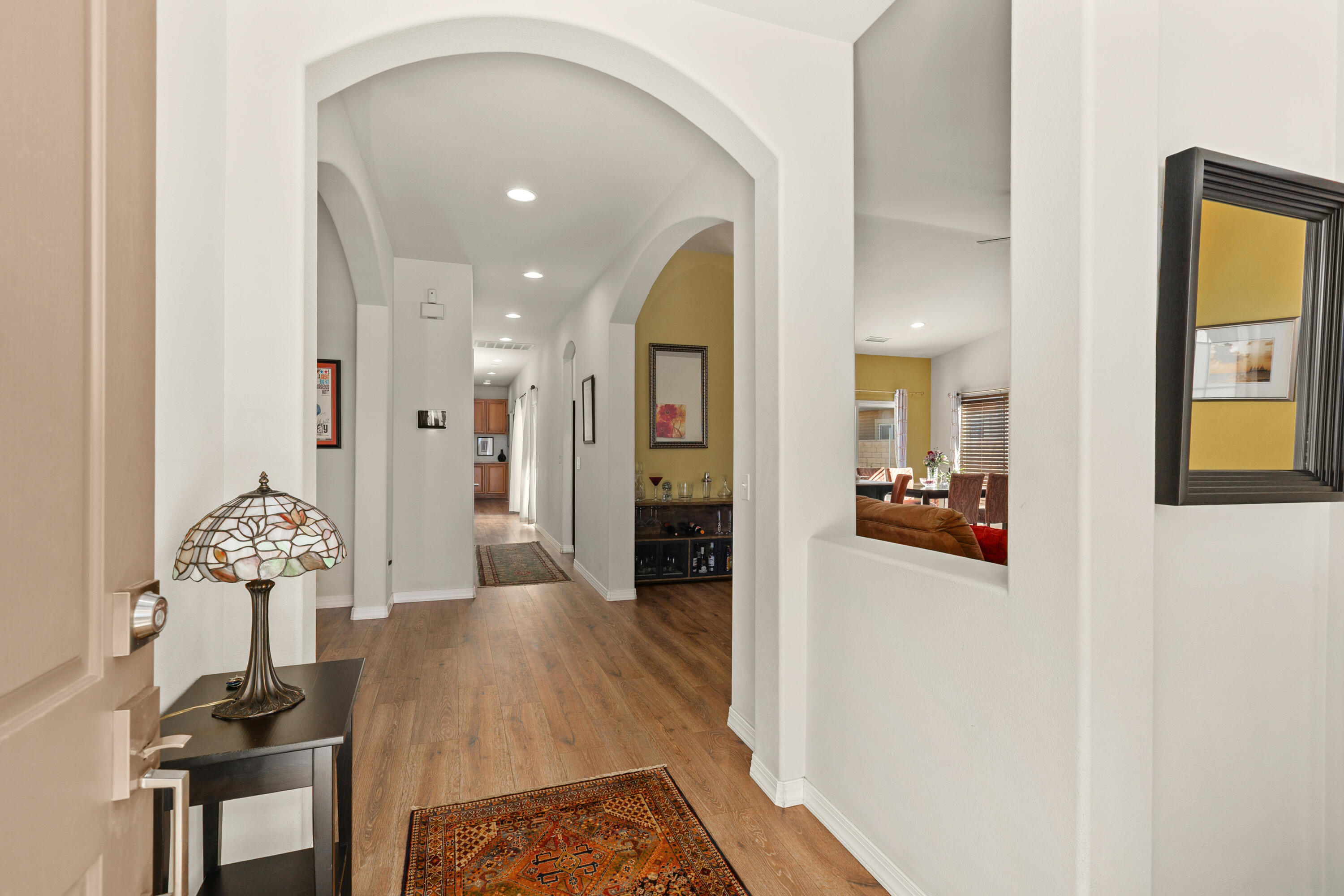 26700 Rio Dulce Road Cathedral City, CA 92234 - Photo 2 of 20 a view of a hallway to a livingroom and a dining room with furniture
