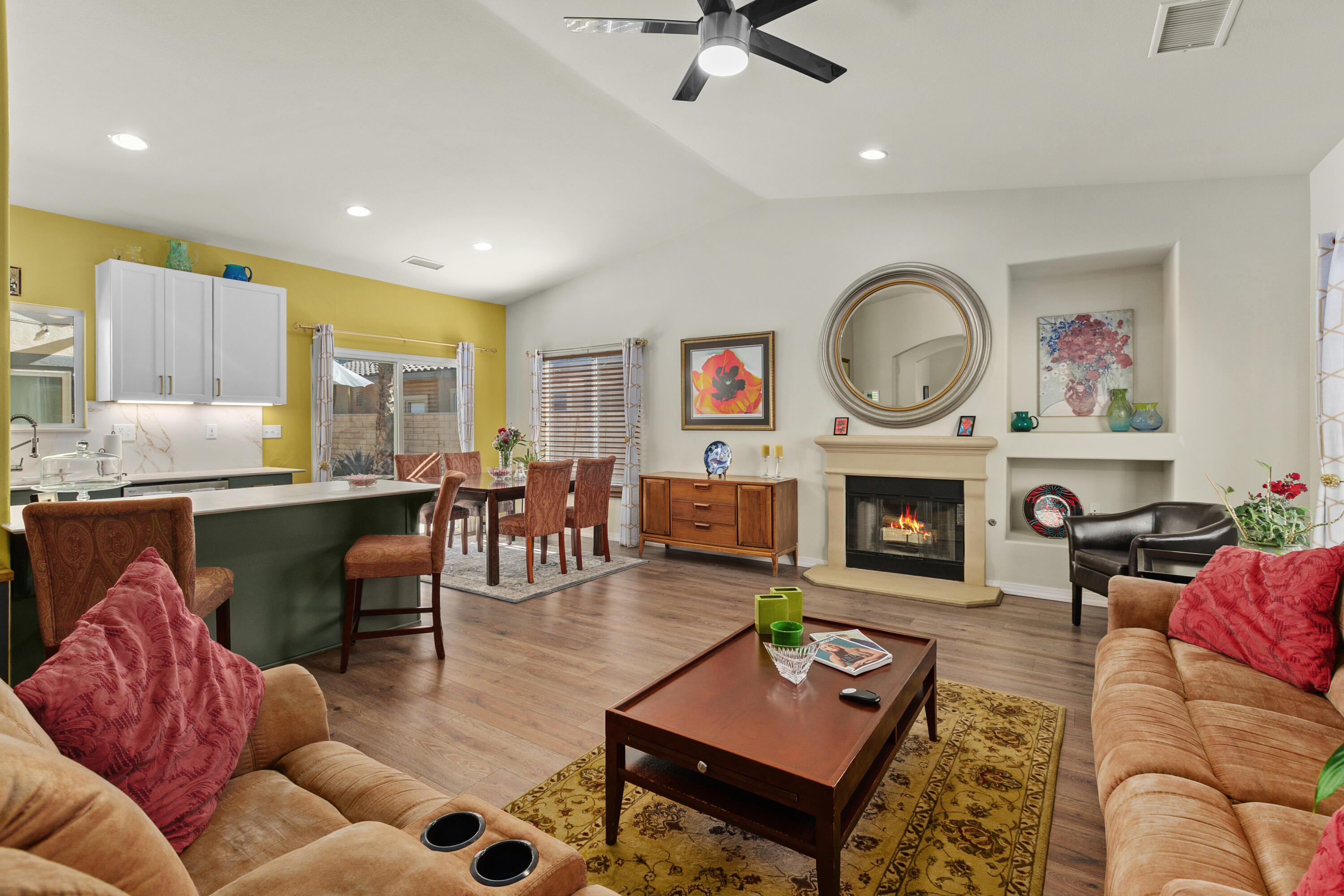 26700 Rio Dulce Road Cathedral City, CA 92234 - Photo 5 of 20 a living room with furniture a fireplace and a large window