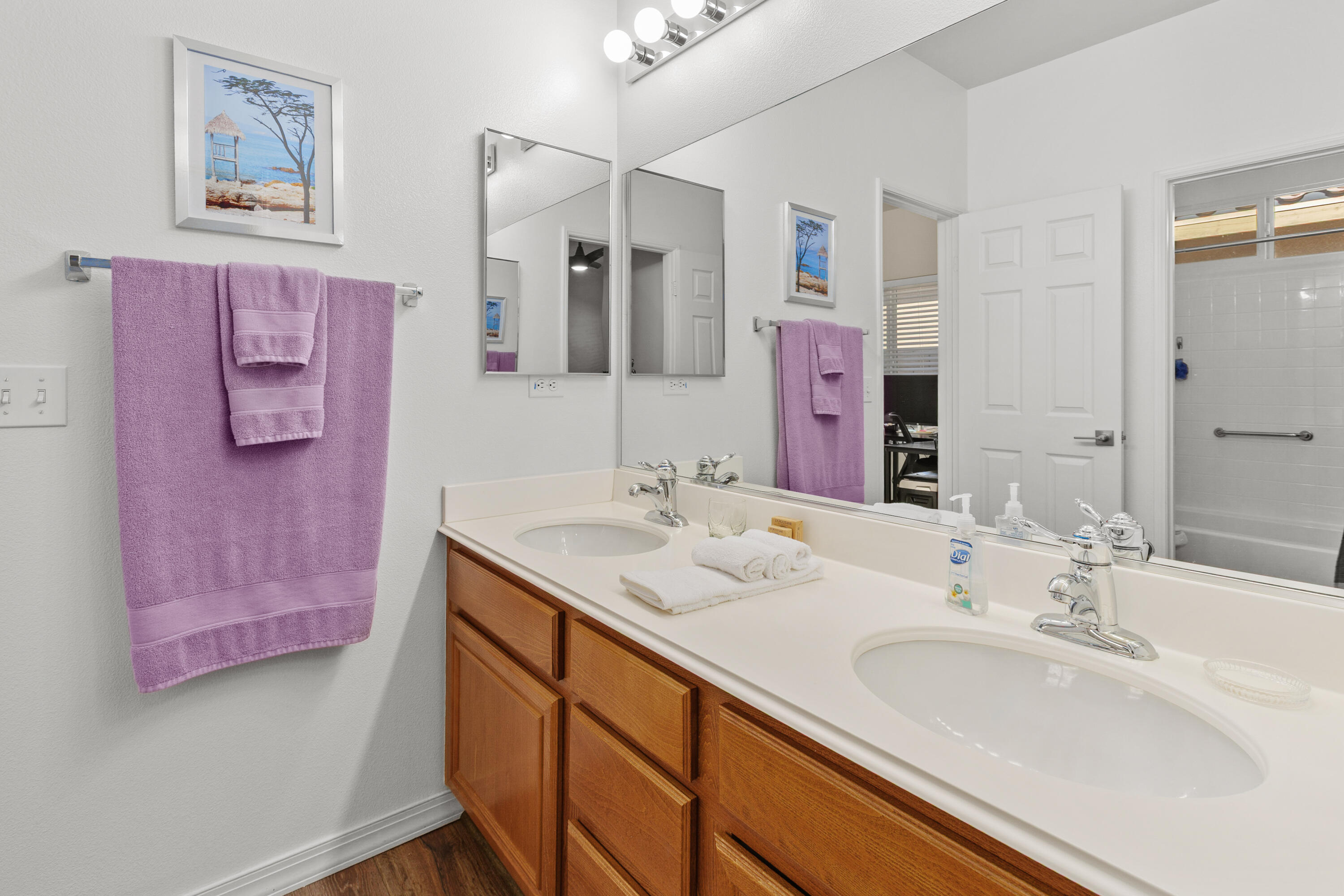 26700 Rio Dulce Road Cathedral City, CA 92234 - Photo 10 of 20 a bathroom with a granite countertop sink a mirror a vanity and a shower