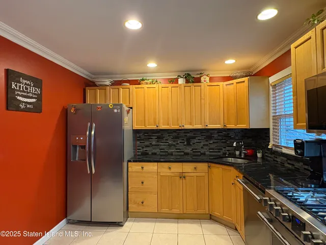 a kitchen with stainless steel appliances granite countertop a refrigerator and a stove