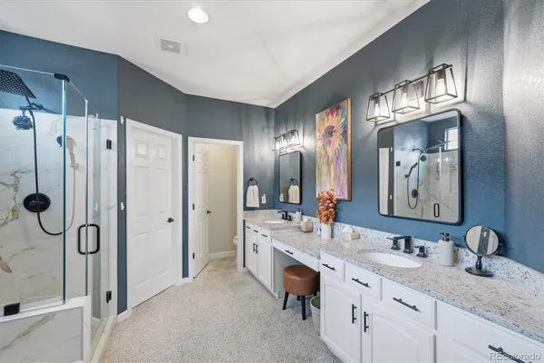 a bathroom with a double vanity sink mirror and double