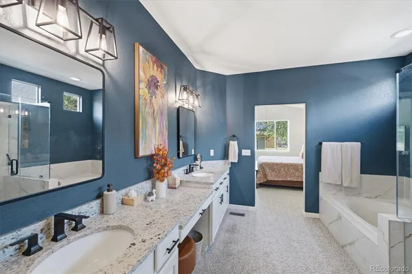 a large bathroom with double vanity sinks a large mirror and a bathtub