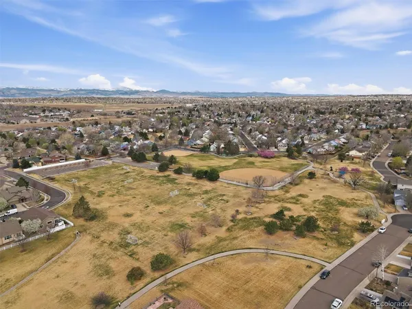 an aerial view of residential houses with outdoor space