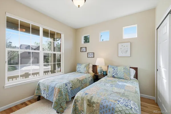 a bedroom with two beds and a window