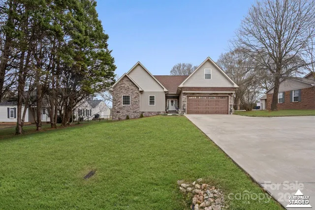 a living room with stainless steel appliances kitchen island a table and chairs