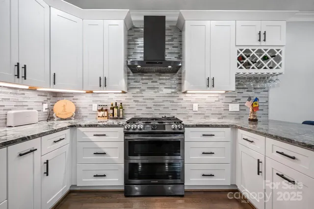 a bathroom with a granite countertop sink vanity mirror and toilet