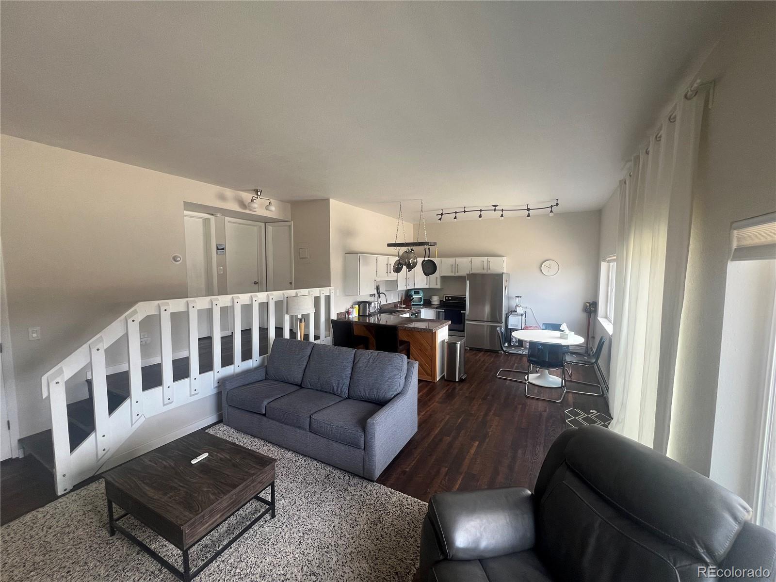 9876 Ryan Gulch Road, Unit 104 Silverthorne, CO 80498 - Photo 3 of 15 a living room with furniture and a table