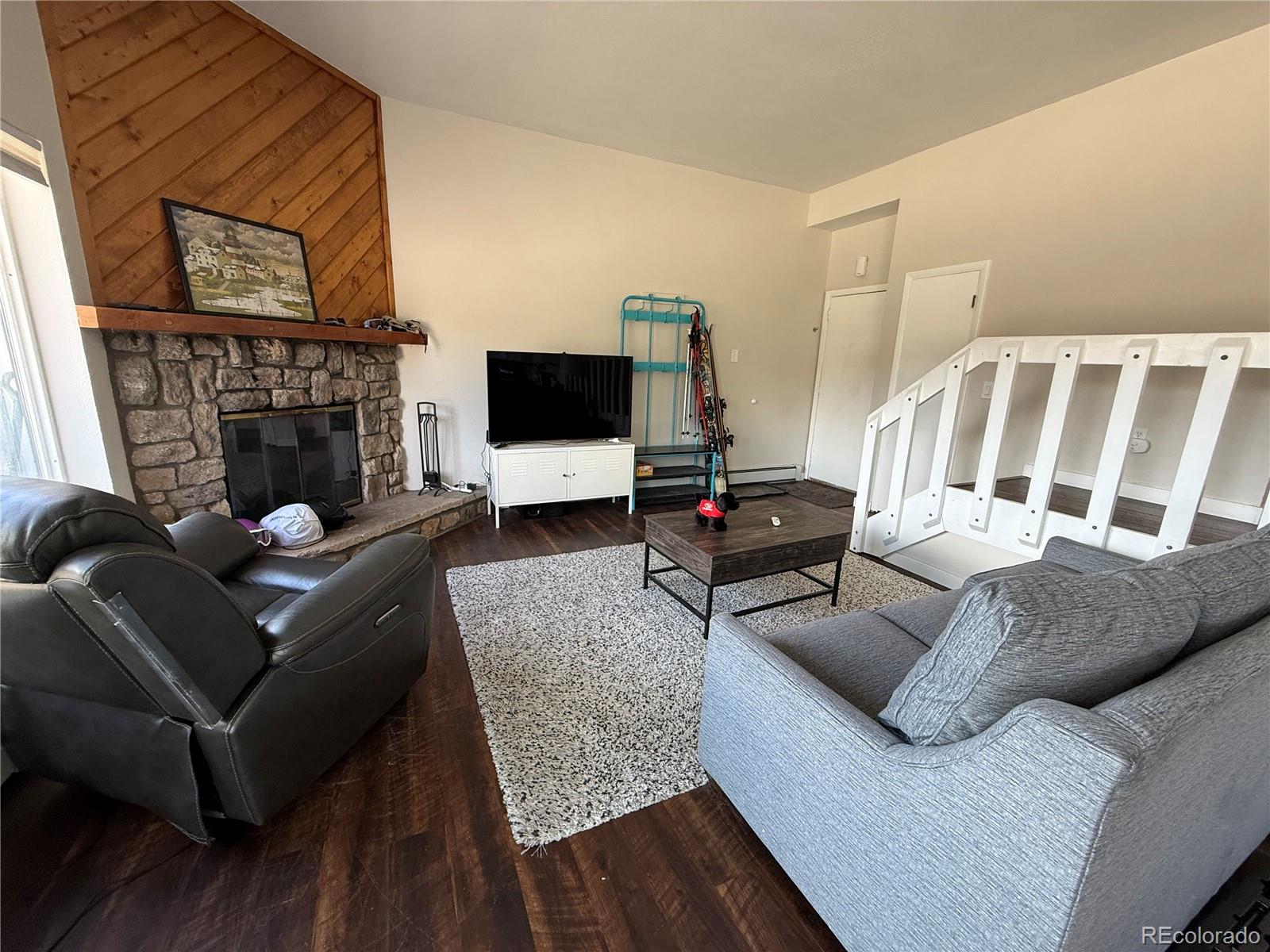 9876 Ryan Gulch Road, Unit 104 Silverthorne, CO 80498 - Photo 7 of 15 a living room with furniture and a fireplace