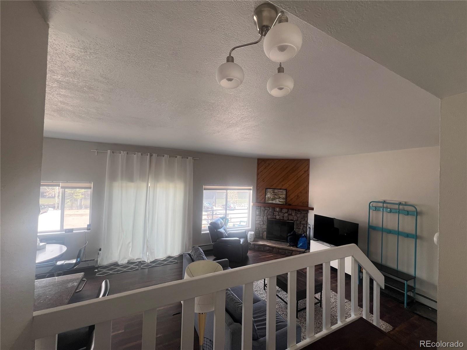 9876 Ryan Gulch Road, Unit 104 Silverthorne, CO 80498 - Photo 9 of 15 a bedroom with furniture and a window