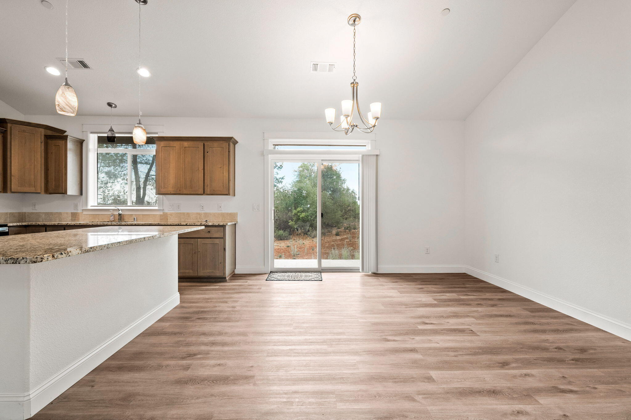 7590 Hopeful Place Shingletown, CA 96088 - Photo 12 of 31 a view of a kitchen with a sink wooden floor and a chandelier