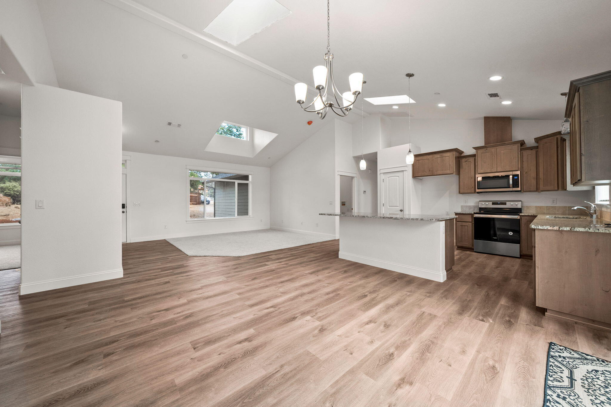 7590 Hopeful Place Shingletown, CA 96088 - Photo 13 of 31 a view of kitchen with granite countertop cabinets stainless steel appliances and a fireplace