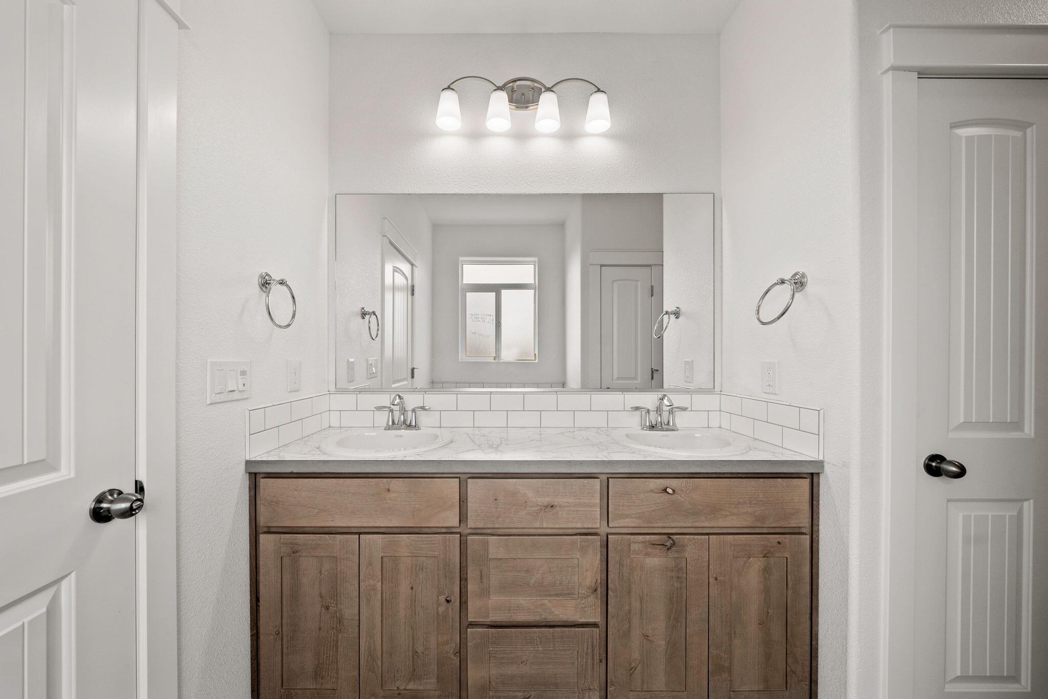 7590 Hopeful Place Shingletown, CA 96088 - Photo 23 of 31 a bathroom with a double vanity sink and a mirror