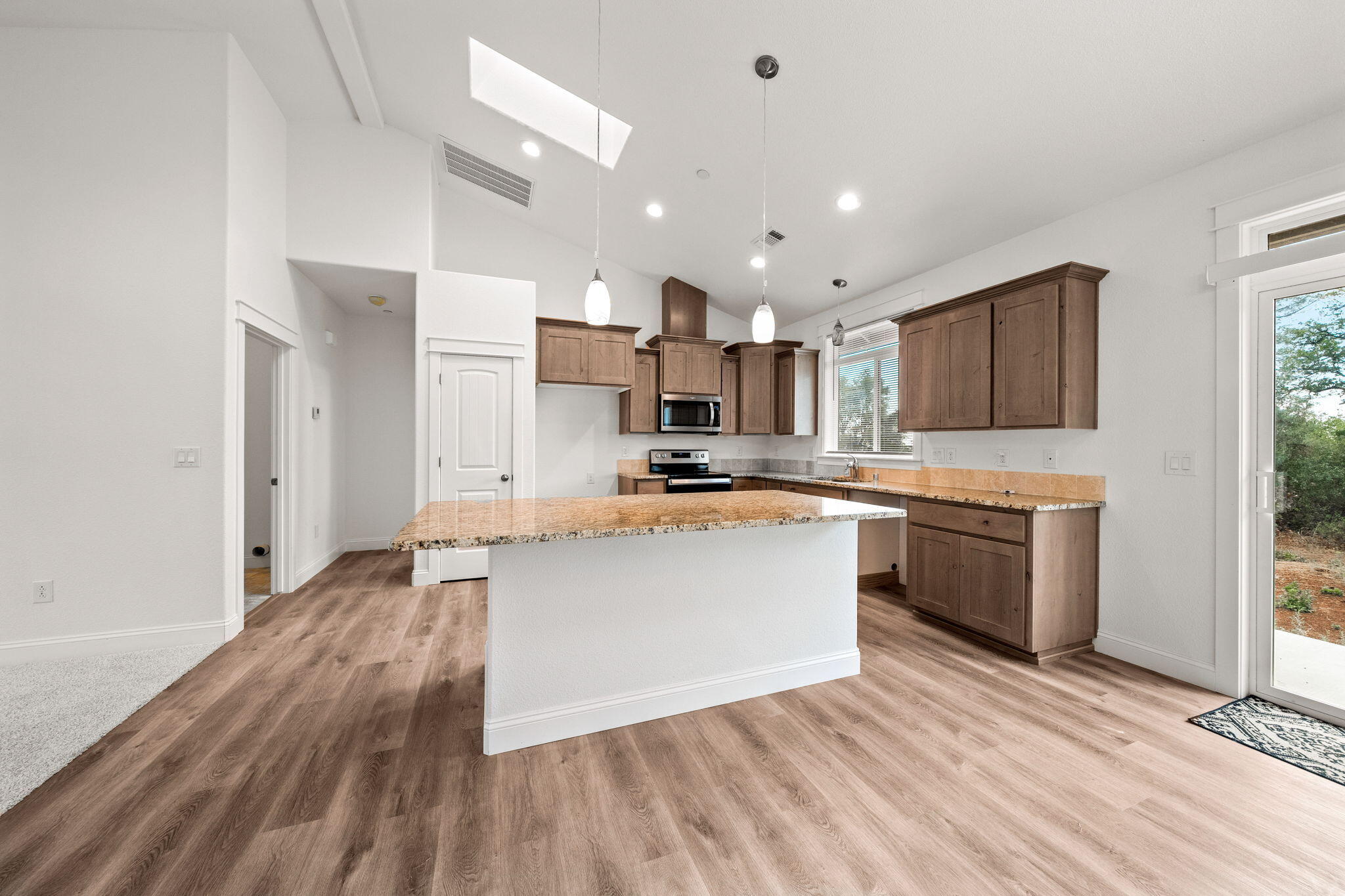 7590 Hopeful Place Shingletown, CA 96088 - Photo 7 of 31 a kitchen with stainless steel appliances granite countertop a stove top oven a sink and a refrigerator