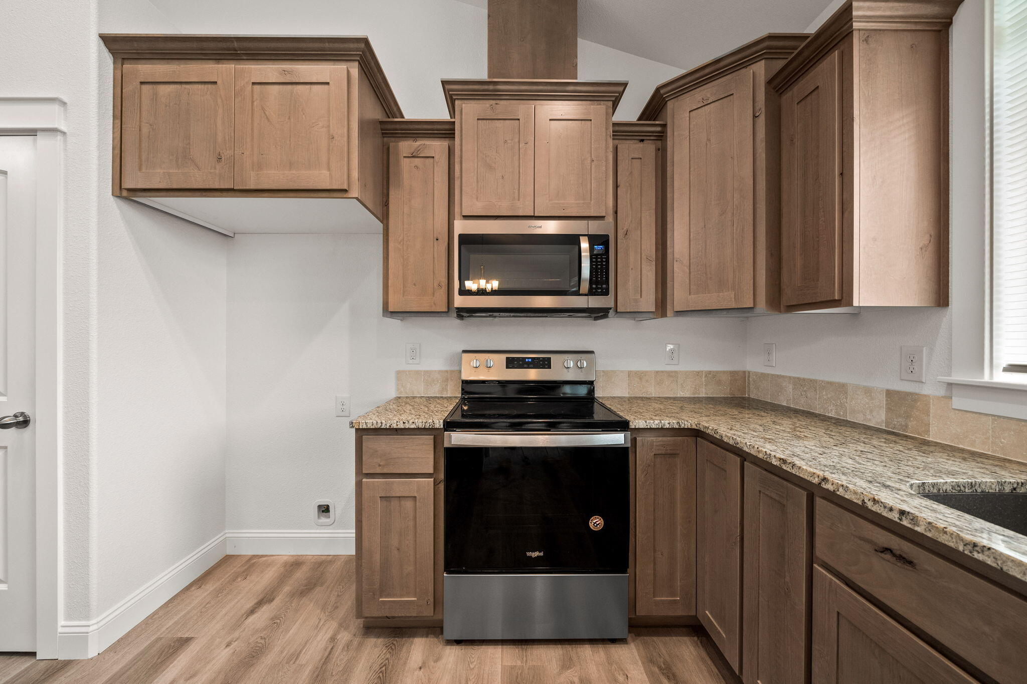 7590 Hopeful Place Shingletown, CA 96088 - Photo 9 of 31 a kitchen with granite countertop a stove top oven microwave and cabinets