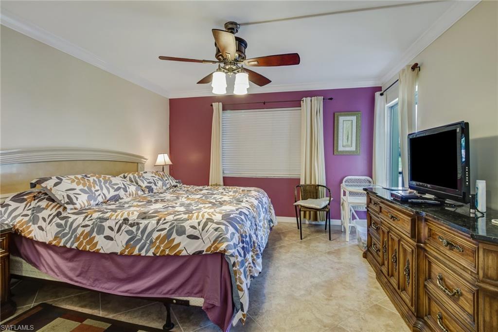 49 High Point Circle South, Unit 102 Naples, FL 34103 - Photo 13 of 42 Master bedroom with sliding door to lanai