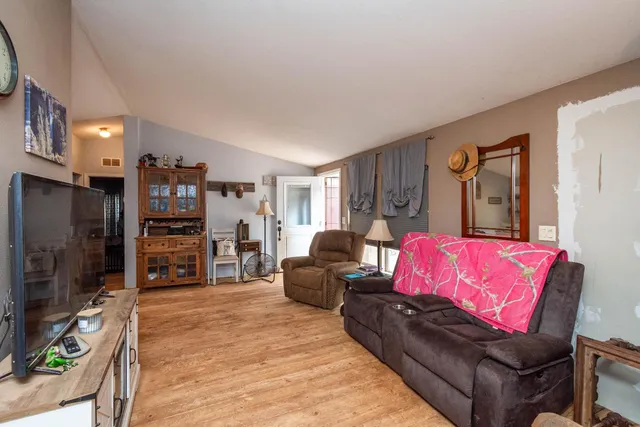 a view of a house with a big yard and large trees