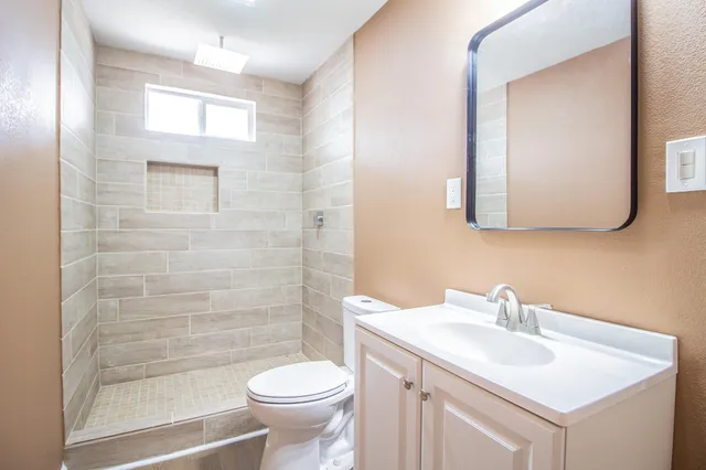 a bathroom with a sink toilet and shower
