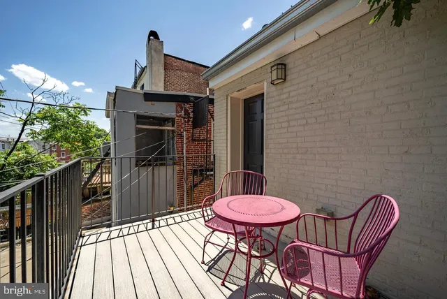 a backyard of a house with table and chairs