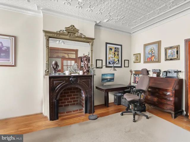 a view of a livingroom with workspace and a window