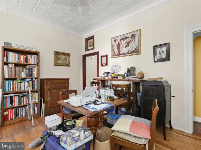 a work room with furniture and a bookshelf
