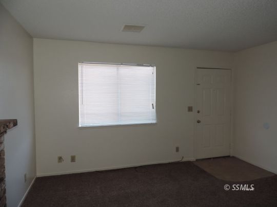405 South Sunset Street Ridgecrest, CA 93555 - Photo 13 of 17 an empty room with a window