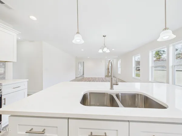 a kitchen with a sink a counter space and cabinets