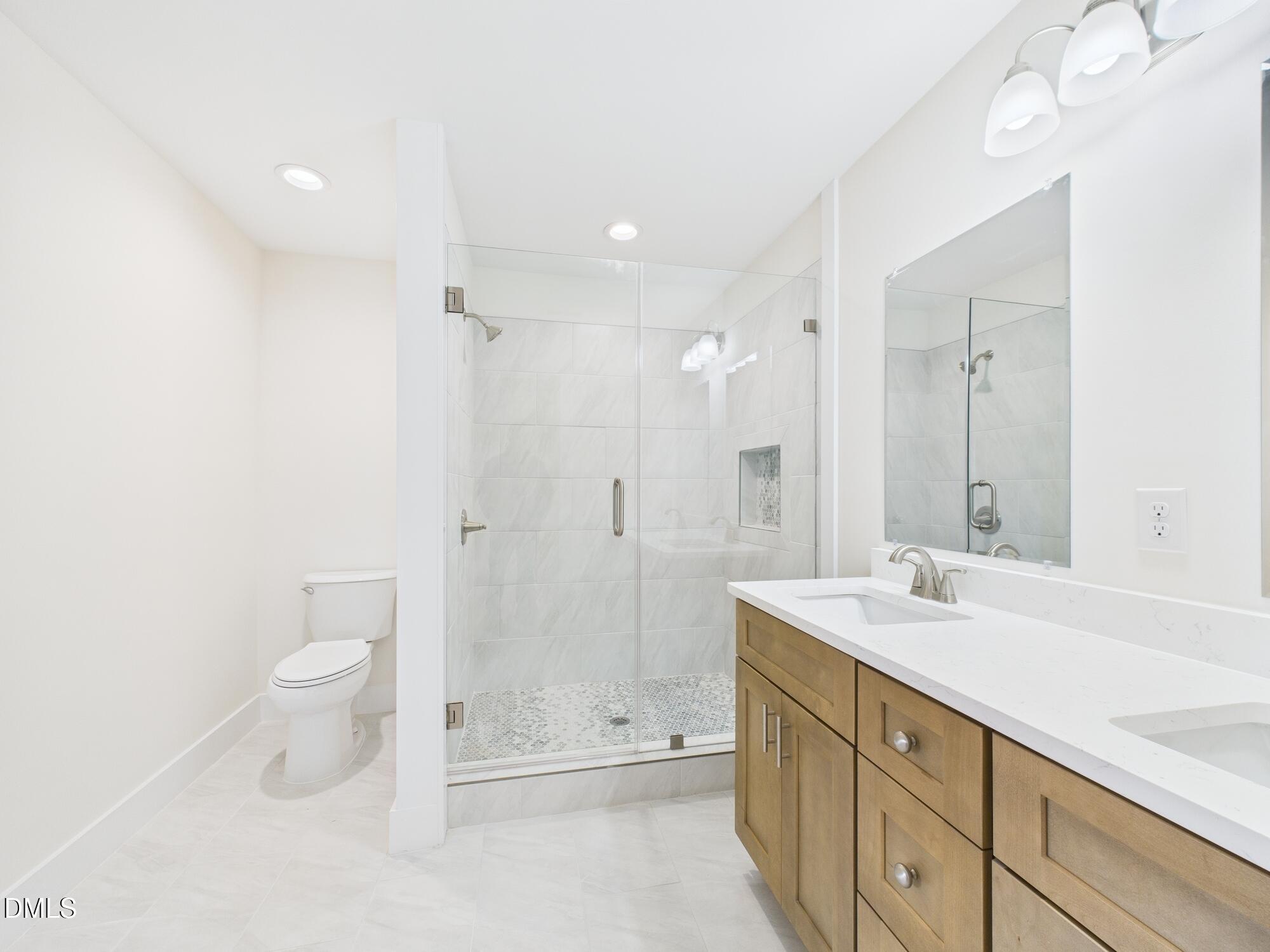 3602 Old Farm Court Graham, NC 27253 - Photo 13 of 25 a bathroom with a double vanity sink toilet and shower