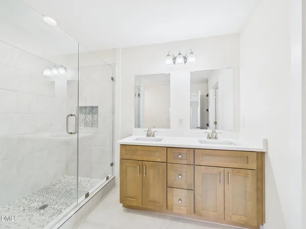 a bathroom with a shower sink and mirror