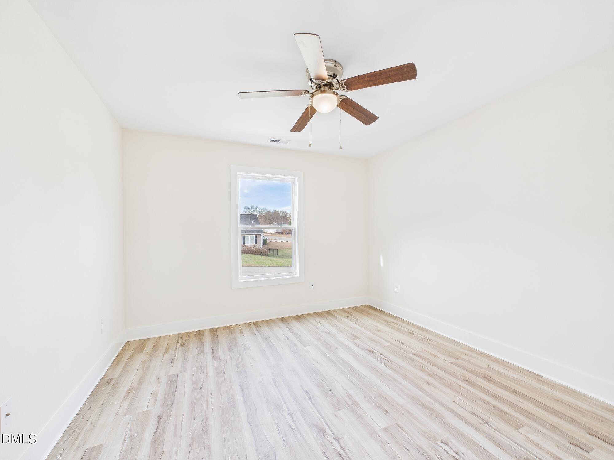 3602 Old Farm Court Graham, NC 27253 - Photo 17 of 25 an empty room with wooden floor closet and fan