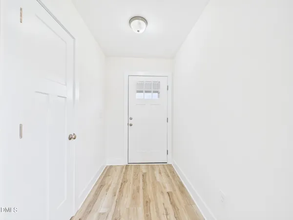 a front view of a house with yard and large tree