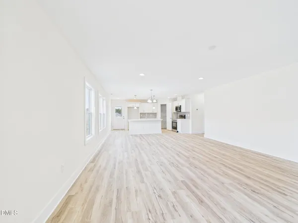 a view of a room with wooden floor
