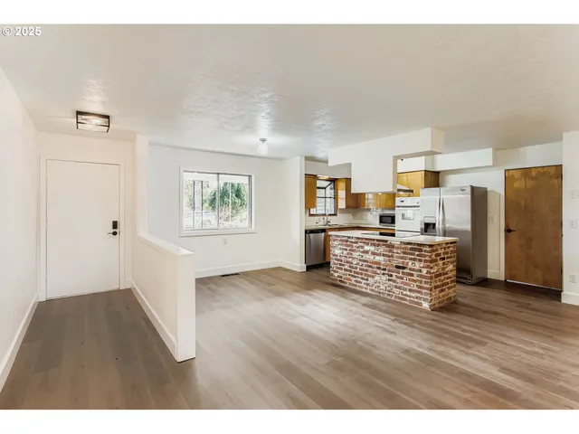 a room with wooden floor and windows