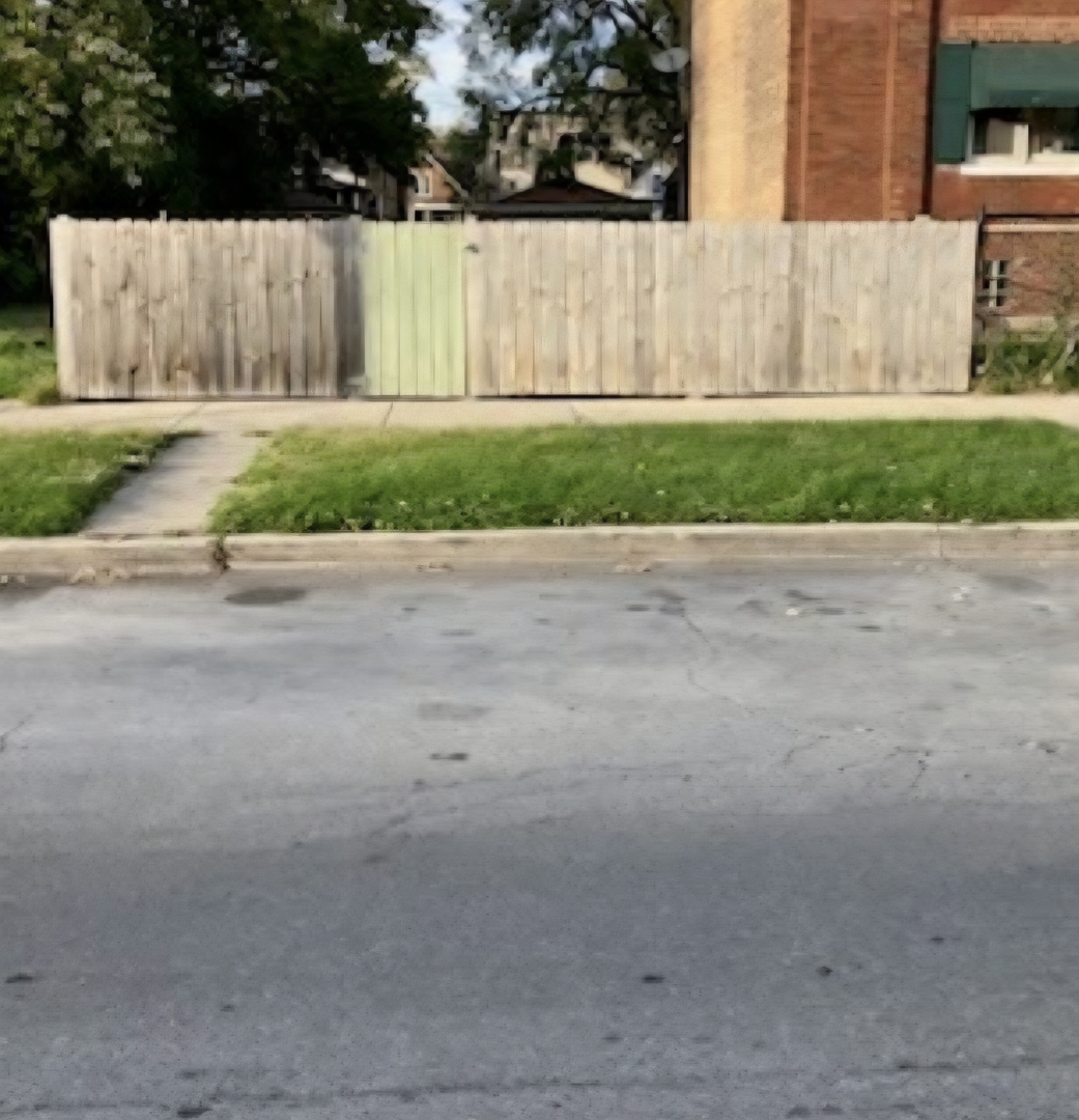 118 West 113th Place Chicago, IL 60628 - Photo 1 of 6 a view of a road with a yard