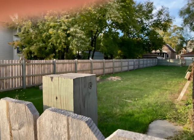 a view of a backyard with table and chairs