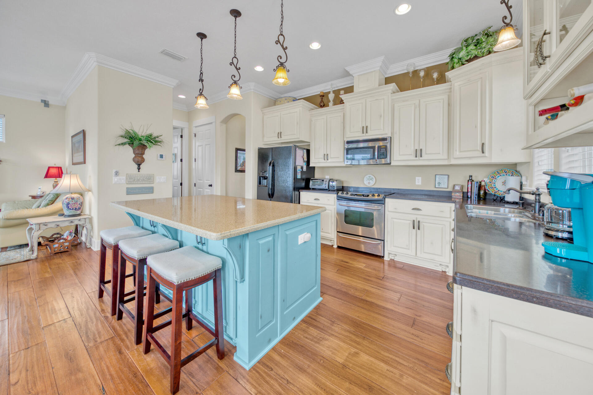 25 Pompano Place Inlet Beach, FL 32461 - Photo 13 of 76 a kitchen with stainless steel appliances granite countertop wooden floors stove refrigerator and cabinets
