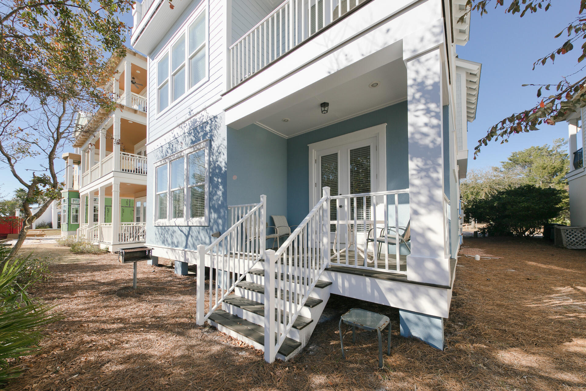 25 Pompano Place Inlet Beach, FL 32461 - Photo 50 of 76 a view of a patio with a table chairs and a floor to ceiling window