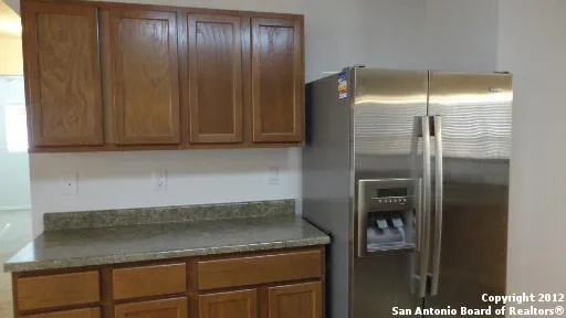 a kitchen with a refrigerator and cabinets