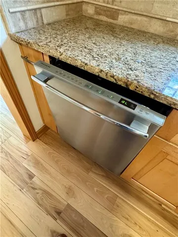 a view of washer and dryer with wooden floor