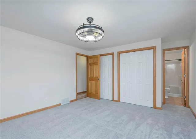 a spacious bedroom with a bed and a couch