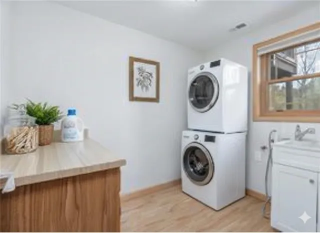 an empty room with a window and wooden floor