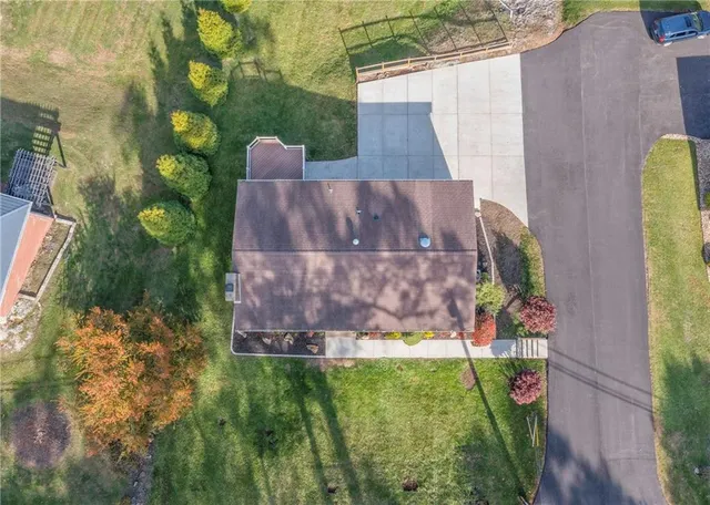 an aerial view of a house with a yard