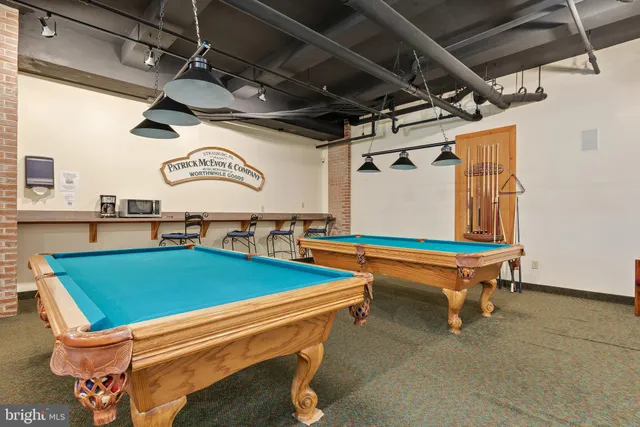 a room with pool table and windows